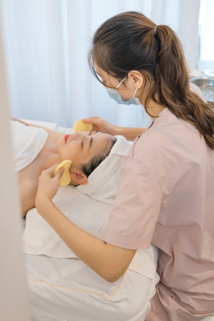 Spa therapist performing a calming facial massage, embodying relaxation and self-care.