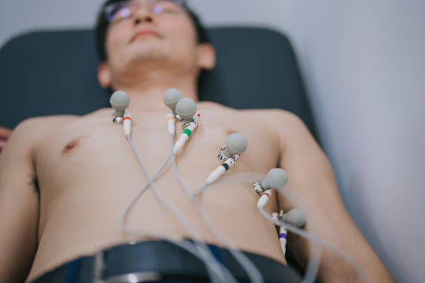 asian chinese male patient electrocardiogram exam at hospital